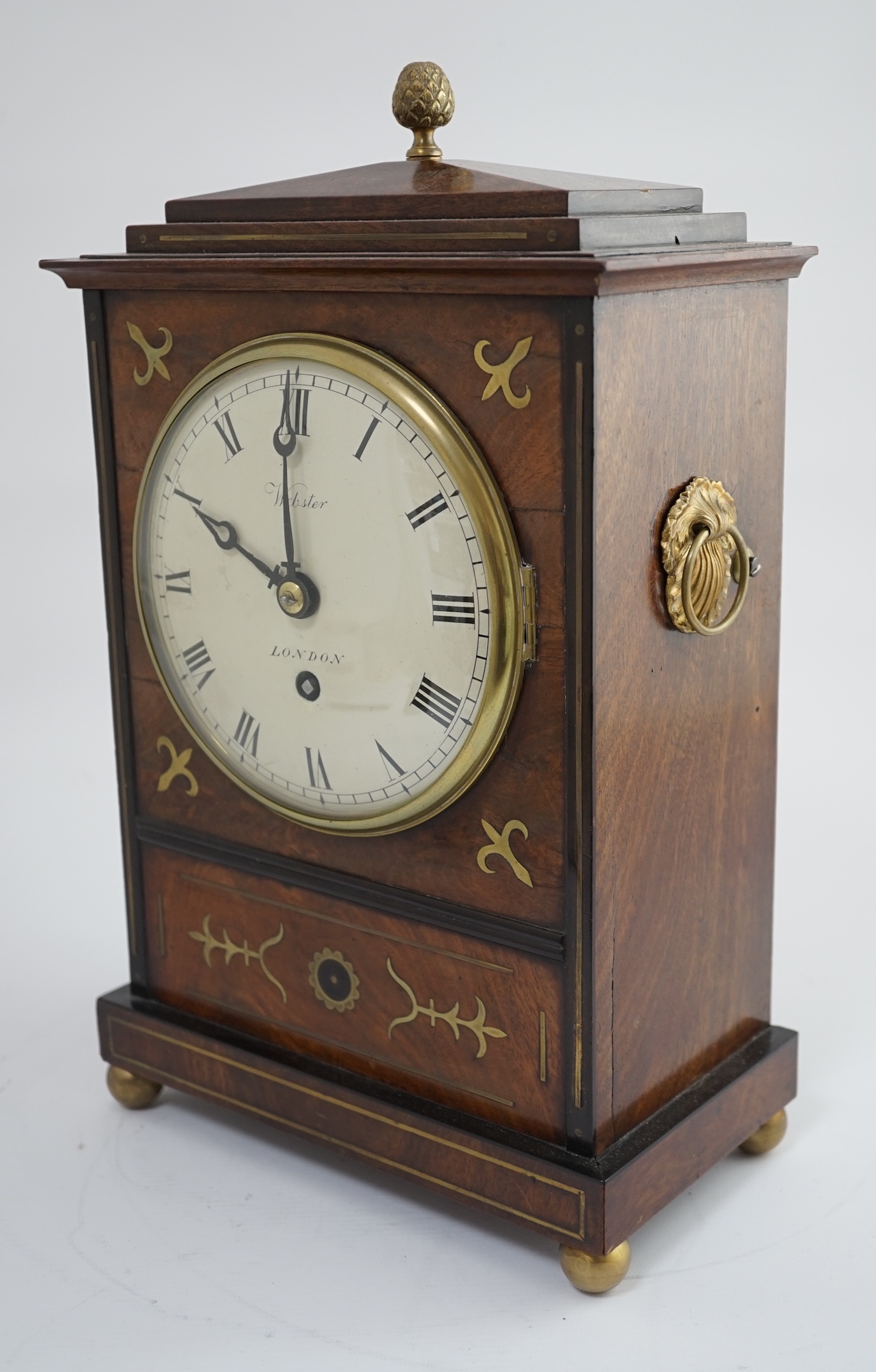 Webster of London. A Regency brass inset and ebonised mahogany bracket timepiece